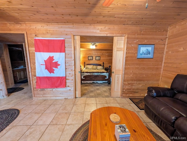 living area with wood ceiling, wood walls, and light tile patterned floors