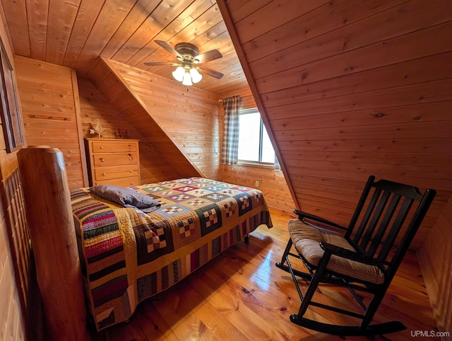 bedroom featuring wooden ceiling, light wood-style flooring, and wooden walls