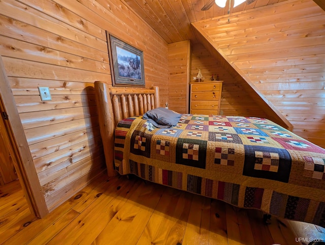 bedroom featuring wood walls, wood-type flooring, and wooden ceiling