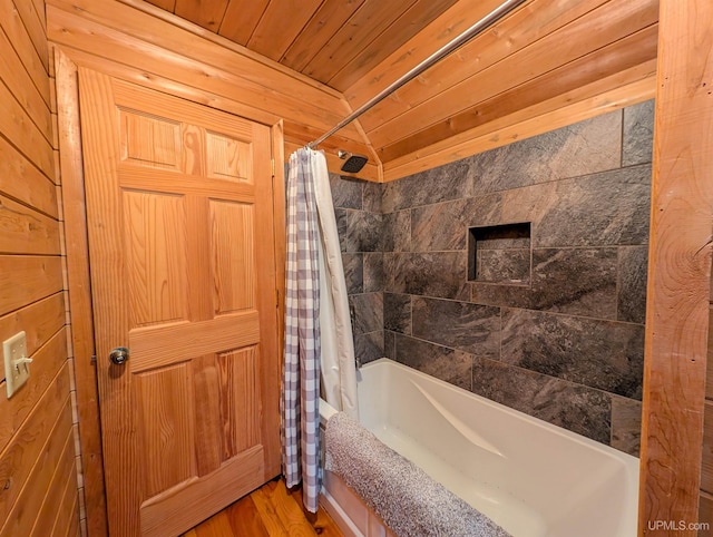 full bathroom with wooden ceiling, shower / bathtub combination with curtain, and wood finished floors