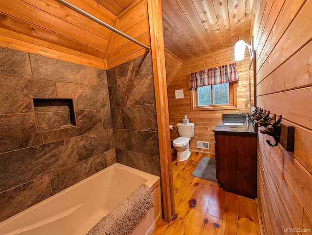 bathroom with visible vents, toilet, wood walls, wooden ceiling, and hardwood / wood-style floors