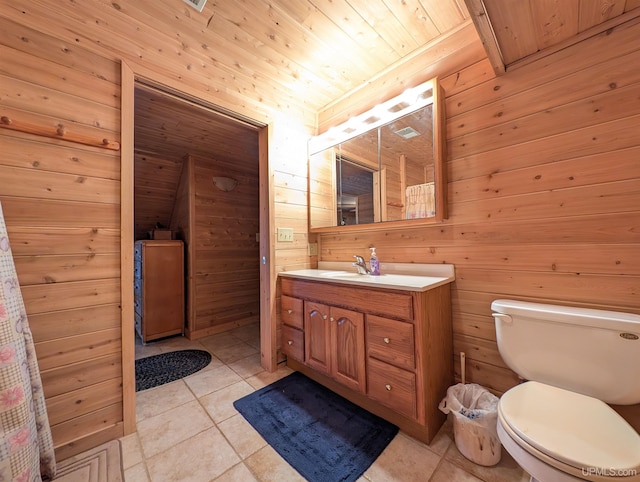 bathroom with toilet, wood walls, wood ceiling, and tile patterned floors