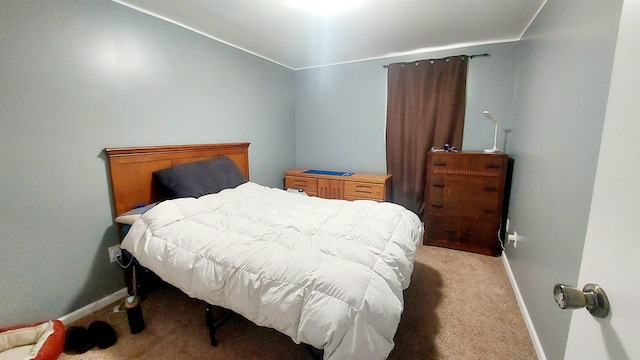 bedroom with light carpet and baseboards