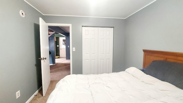 bedroom with light carpet, a closet, and baseboards