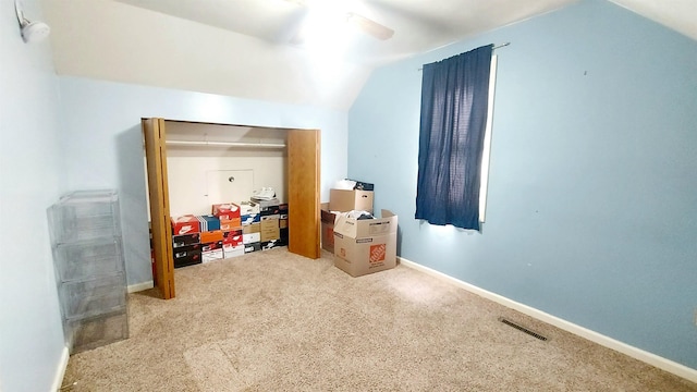 additional living space with lofted ceiling, ceiling fan, carpet floors, visible vents, and baseboards