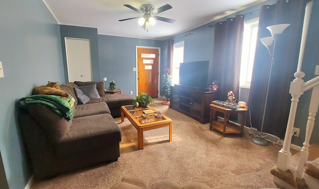 carpeted living area with ceiling fan