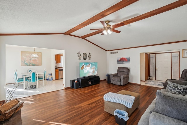 living area featuring vaulted ceiling with beams, ceiling fan, a textured ceiling, wood finished floors, and visible vents