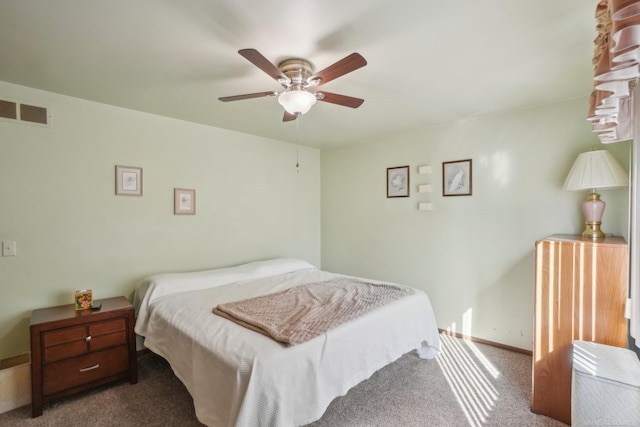 carpeted bedroom with a ceiling fan, visible vents, and baseboards