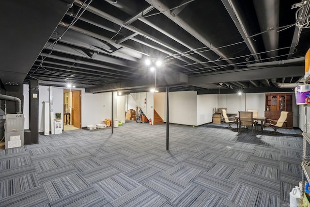 finished basement featuring carpet floors and heating unit