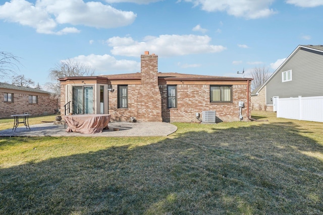 rear view of property featuring a patio area, a lawn, fence, and central AC unit