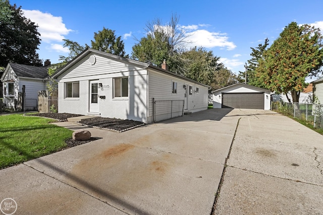 view of front of home featuring an outbuilding, brick siding, a detached garage, fence, and a chimney