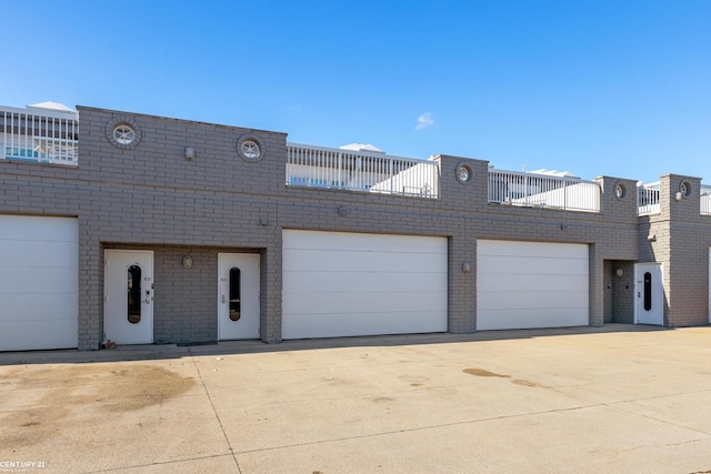 view of front facade featuring a garage, concrete driveway, and brick siding