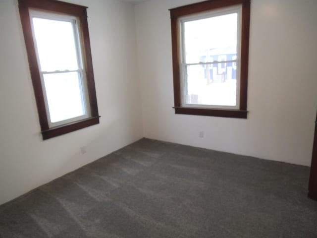 empty room with dark colored carpet