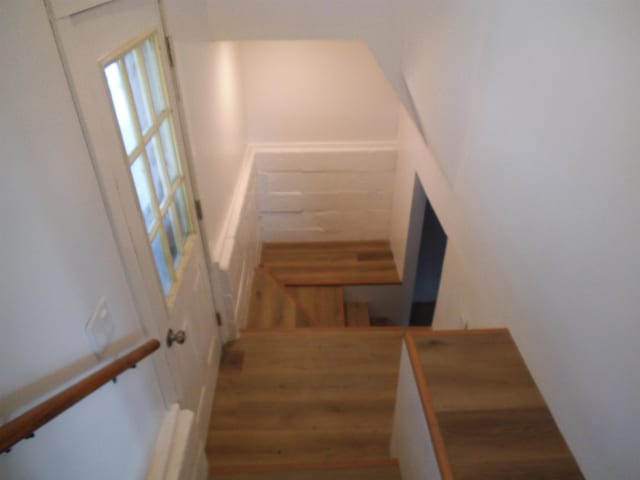 staircase featuring wood finished floors