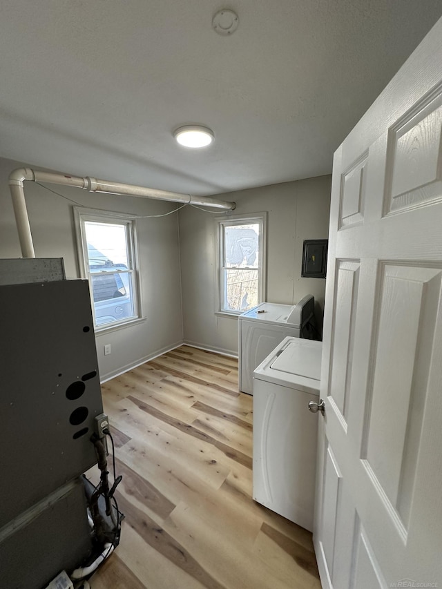 laundry room with laundry area, light wood-type flooring, and washer and dryer