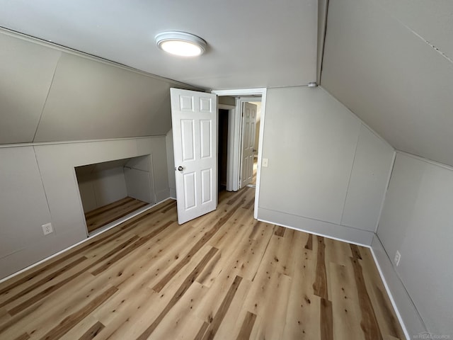 bonus room featuring lofted ceiling and wood finished floors