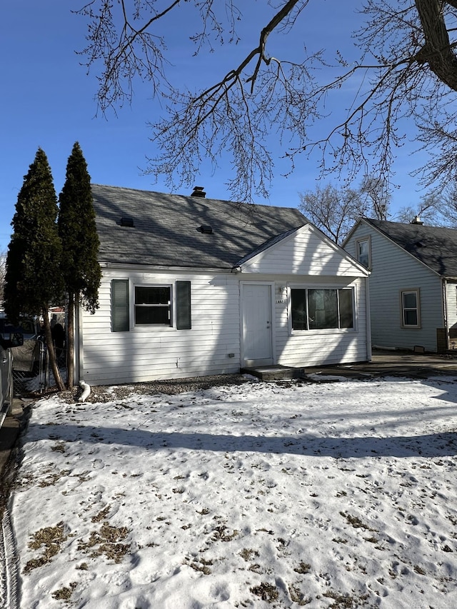 view of snow covered rear of property