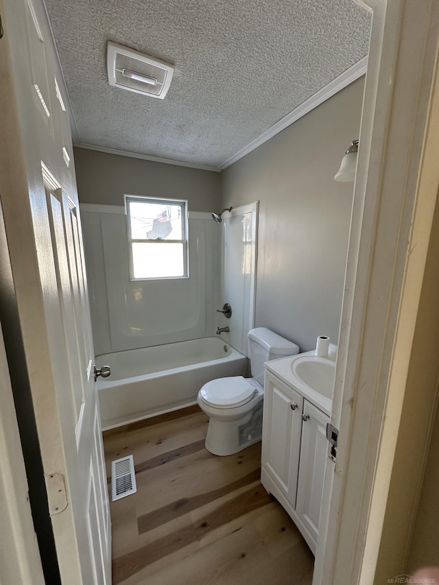 full bath with ornamental molding, toilet, shower / tub combination, and wood finished floors