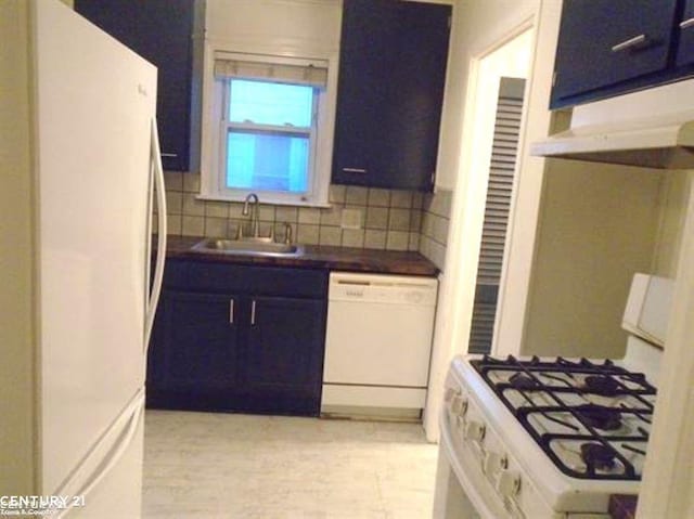 kitchen with white appliances, dark countertops, blue cabinets, a sink, and backsplash