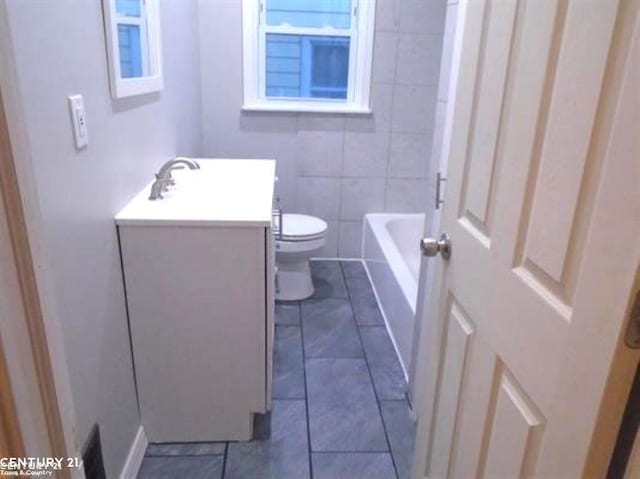 bathroom with toilet, a shower, vanity, and a bath