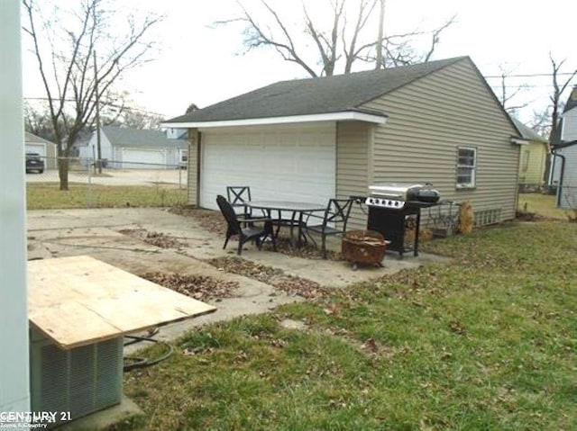 rear view of house with a garage and a lawn