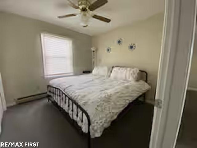 bedroom with baseboard heating and a ceiling fan