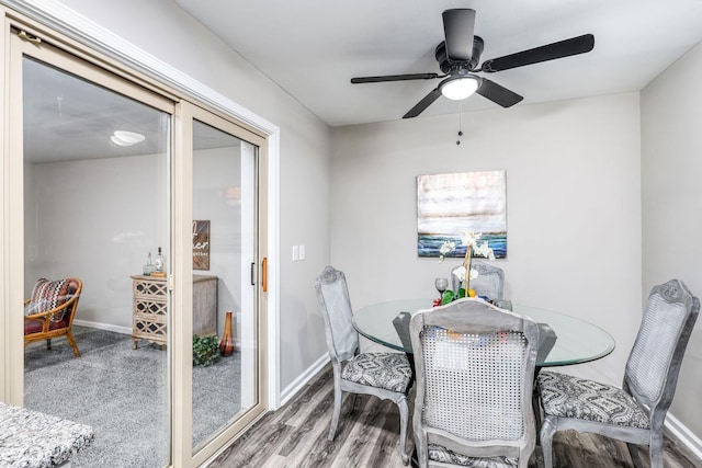 dining area featuring a ceiling fan, baseboards, and wood finished floors