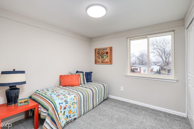 carpeted bedroom featuring baseboards