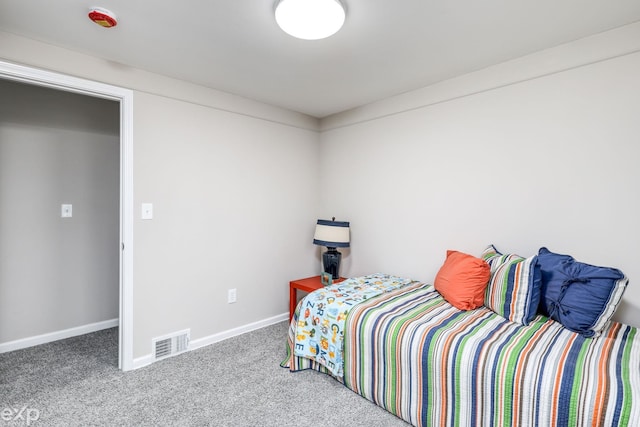 bedroom with carpet floors, visible vents, and baseboards