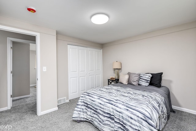 carpeted bedroom with a closet, visible vents, and baseboards