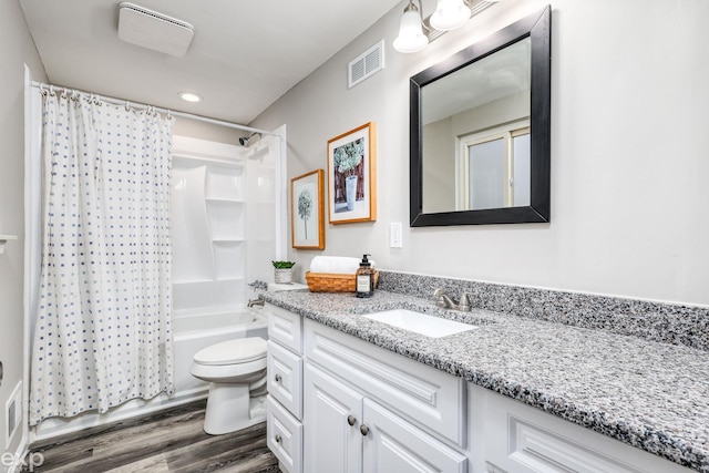 bathroom with shower / tub combo with curtain, visible vents, toilet, vanity, and wood finished floors