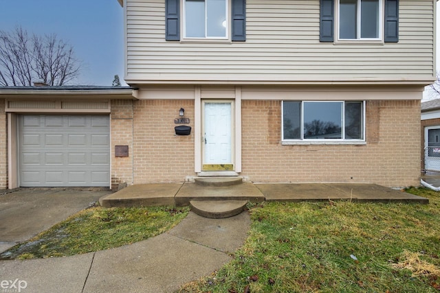 doorway to property featuring a garage and brick siding