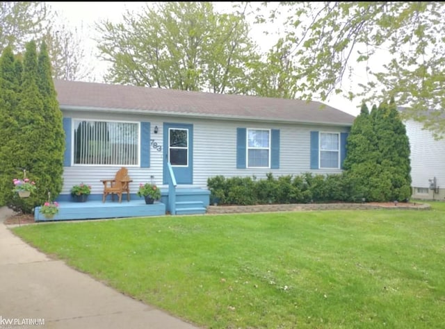 ranch-style home with a front lawn