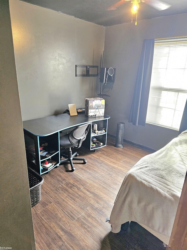 bedroom featuring ceiling fan and wood finished floors