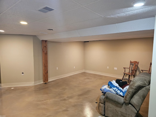 unfurnished room with a drop ceiling, visible vents, and finished concrete floors