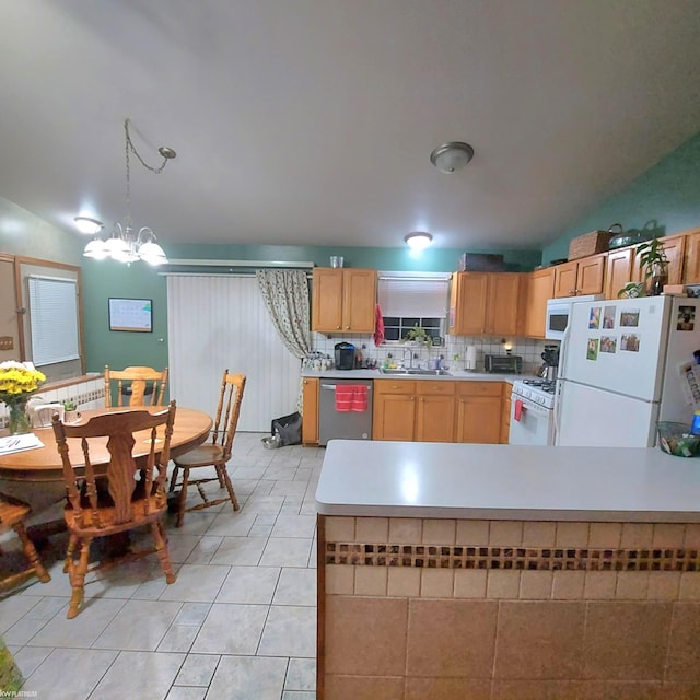 kitchen with light countertops, white appliances, a sink, and tasteful backsplash