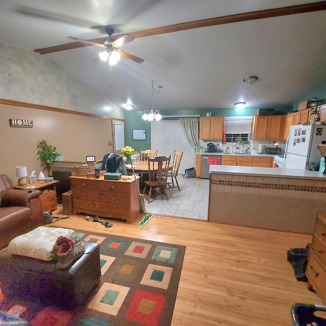 living room with lofted ceiling, ceiling fan with notable chandelier, and light wood-style floors