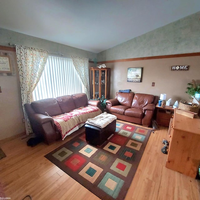 living room with lofted ceiling and wood finished floors