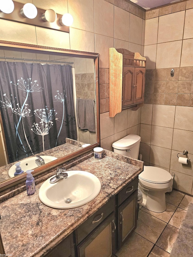 bathroom with toilet, vanity, tile walls, and a shower with curtain