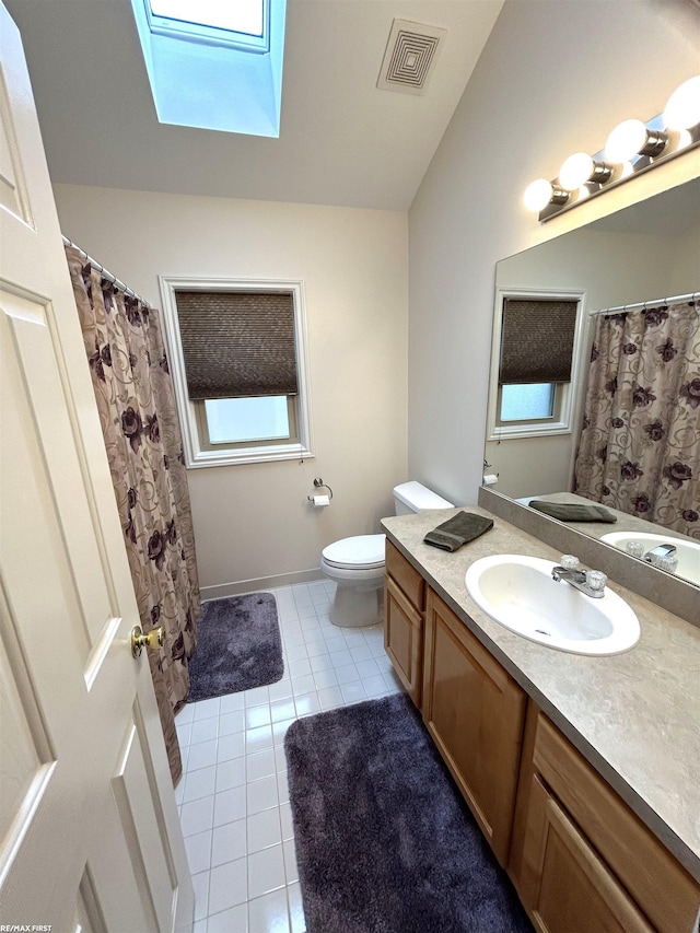 bathroom featuring visible vents, toilet, tile patterned floors, vanity, and a healthy amount of sunlight