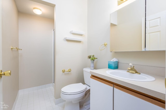 bathroom with baseboards, toilet, tile patterned floors, walk in shower, and vanity