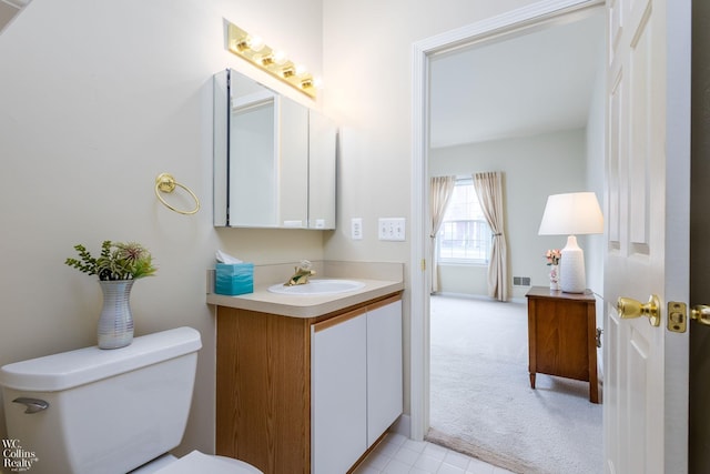 half bathroom featuring vanity and toilet