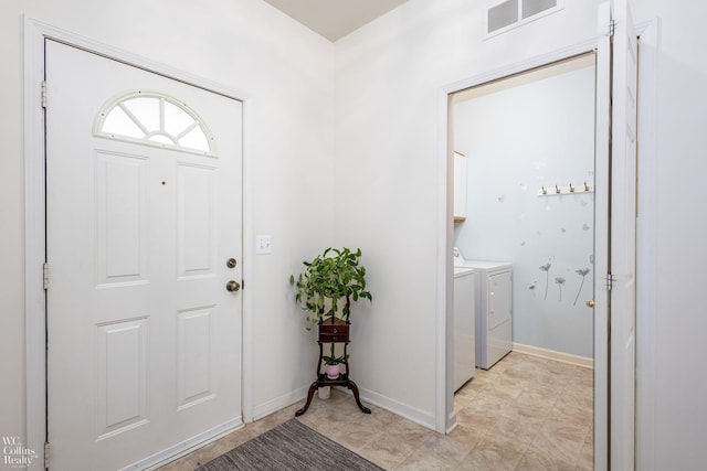 entrance foyer featuring independent washer and dryer, visible vents, and baseboards