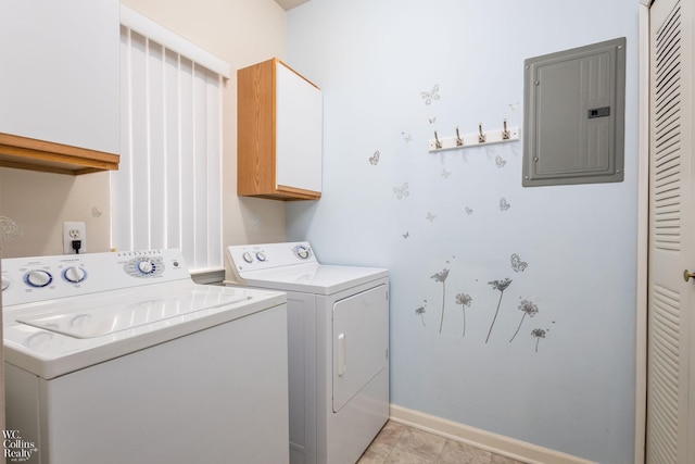 washroom featuring washing machine and dryer, electric panel, cabinet space, and baseboards