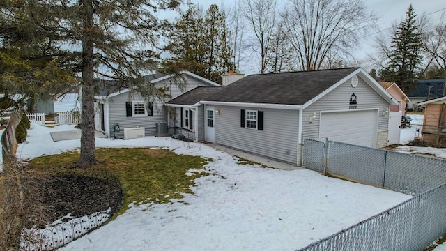 ranch-style house featuring driveway, a chimney, an attached garage, and fence