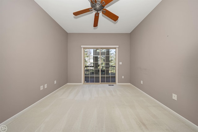 unfurnished room with visible vents, baseboards, light colored carpet, and ceiling fan