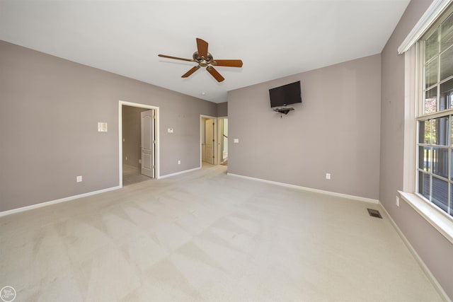 unfurnished room featuring visible vents, baseboards, light carpet, and ceiling fan