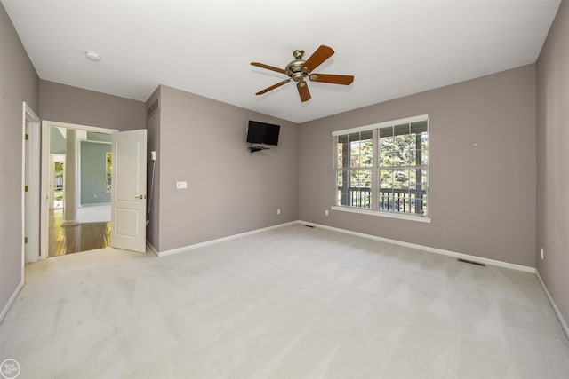 unfurnished bedroom with visible vents, baseboards, light colored carpet, and ceiling fan