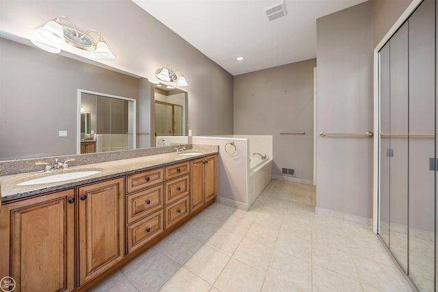 full bathroom with tile patterned flooring, visible vents, a bath, and a sink