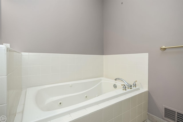 full bath with visible vents and a jetted tub